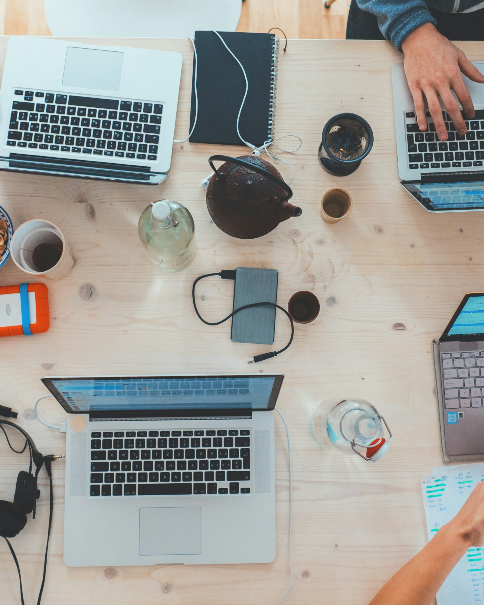 Colleagues collaborating around laptops in an open workspace